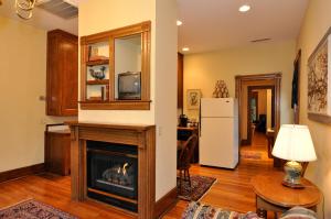 a living room with a fireplace and a refrigerator at Bluff View Inn in Chattanooga