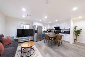 Una sala de estar con un sofá y una mesa y una cocina. en Modern Luxe Ensuite by USC Shared Living, en Los Ángeles
