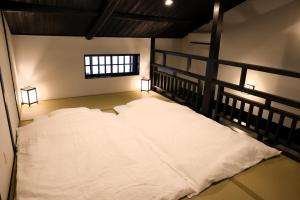 a bedroom with two white beds in it at 辰巳屋 Tatsumiya in Osaka +106 photos