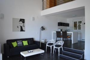 a living room with a black couch and chairs at Holiday Home Anna in Klek