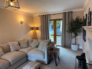 a living room with a couch and a window at Foyleview Point in Balnacart