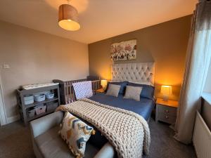 a small bedroom with a bed and a couch at Foyleview Point in Balnacart