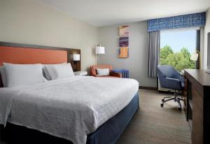 a hotel room with a bed and a chair and a window at Hampton Inn Meridian in Meridian +23 photos