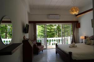 a bedroom with a bed and a balcony at Baan Suan Villa 1 in Patong Beach +114 photos
