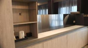 a kitchen with wooden cabinets and a counter top at M1 North Point Hotel in Hong Kong