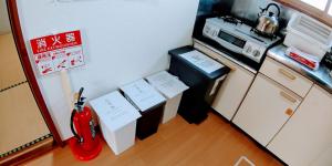 a miniature kitchen with a guitar and a microwave at 布施温泉ステイ　ウエスト in Saku +22 photos