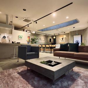 a living room with two couches and a table at Shiki Art Hotel Yufu in Yufu