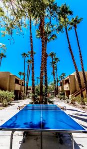 a blue table with palm trees in the background at Desert Vacation Villas, a VRI resort in Palm Springs