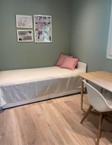 a bed in a room with a table and a desk at Guest house with sauna and private beach in Inkoo +24 photos