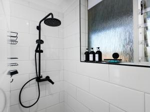 a shower with a shower head in a bathroom at Sandy Shores On Beach - 709 in Strand +38 photos