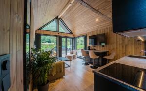a kitchen and living room of a house with a large window at Flåm Minisuite in Aurland