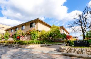 a house on the side of a road at Temple Town Hotel WAQOO Horyuji in Ikaruga