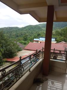 a balcony with a view of a roof at Gloria Guest House in Latuhalat