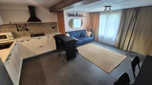 a kitchen with a blue couch and a living room at Studio Rochefort centre 5 minutes à pied in Rochefort