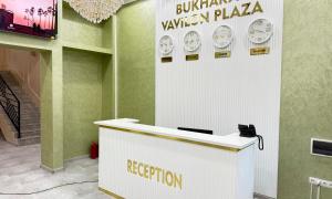 a reception desk in a building with aidiumzavention sign at Bukhara Vavilon Plaza Hotel in Bukhara
