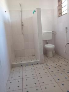 a bathroom with a shower and a toilet at Dannys&nickson holiday homes in Watamu +8 photos