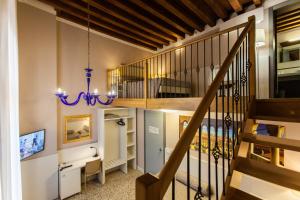 a staircase in a home with a chandelier at Foresteria Levi in Venice