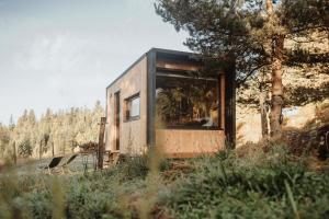 a tiny house sitting in the middle of a field at Refuge panoramique en Haute-Loire in Saint-Julien-Molhesabate