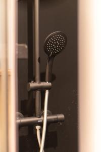 a hair dryer in front of a mirror at Refuge panoramique en Haute-Loire in Saint-Julien-Molhesabate