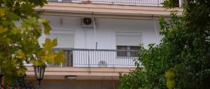 a white building with a balcony with a window at Aridaia Central Square Apartment in Aridaia