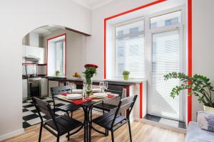 a kitchen and dining room with a table and chairs at Kvartira XL in Minsk
