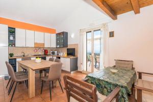 a kitchen and a dining room with a table and chairs at Oasi Dell'Etna in Belpasso +21 photos