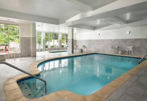 a swimming pool with blue water in a hotel room at Hilton Garden Inn Meridian in Meridian +22 photos