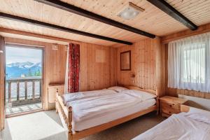 a bedroom with two beds and a large window at Casetta di Carì by Quokka 360 - spacious family flat in Cala