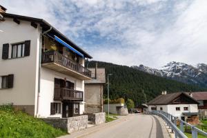 a building on a street with mountains in the background at Casetta di Carì by Quokka 360 - spacious family flat in Cala +26 photos