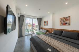 a bedroom with a bed and a large window at Twilight Townhouse w Lift in Hanoi