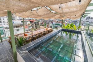 a pool on the roof of a building at Twilight Townhouse w Lift in Hanoi