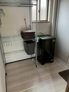 Cette petite chambre comprend un bureau et une télévision. dans l'établissement 1棟貸新築ロフトハウスK2 安濃津 Suzuka ise, à Tsu