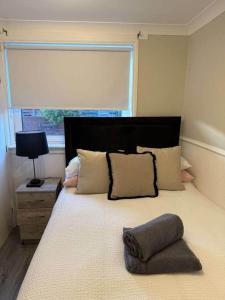 a bedroom with a large bed with a large window at Modern 2BR Sleeps 4 Central Scotland with Parking in Banknock