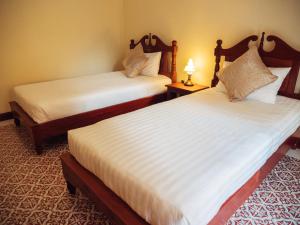 Postel nebo postele na pokoji v ubytování Le Jardin Hotel
