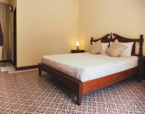 Postel nebo postele na pokoji v ubytování Le Jardin Hotel