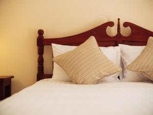 Postel nebo postele na pokoji v ubytování Le Jardin Hotel