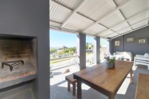 a living room with a table and a fireplace at Talana's Stay - 17 Hugo in Bredasdorp