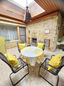 a patio with a table with yellow pillows and chairs at Ferienwohnung Stadtmitte in Braunfels +7 photos