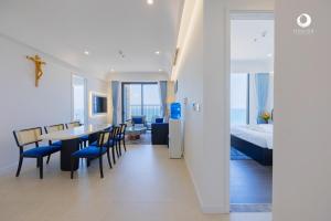 a room with a table and chairs and a bedroom at Solara Apartment Firework & Sunset View in Phú Quốc