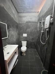 a small bathroom with a toilet and a sink at Cam u view Guest House in Nongkhiaw