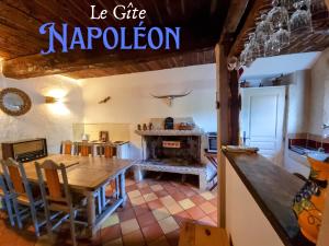 a kitchen with a wooden table and a fireplace at Bastide Napoléon in Séranon