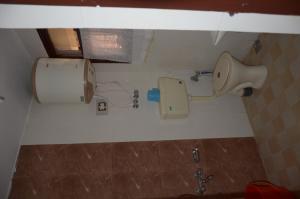 a bathroom with a toilet and a sink in it at Howrah Guest House in Srinagar