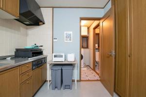 a kitchen with a stove and a counter top at ever Inn Asagaya in Tokyo