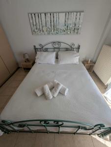 a bedroom with a bed with two towels on it at Byron suite in Kavala +11 photos
