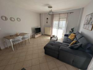 a living room with a couch and a table at Byron suite in Kavála