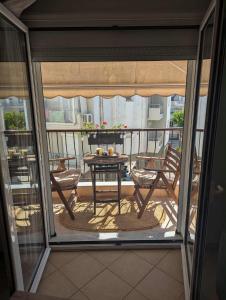 a view of a balcony with a table and chairs at Byron suite in Kavala