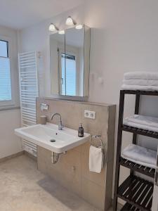 a bathroom with a sink and a mirror at 2-Zimmer Wohnung direkt in der Altstadt in Nürnberg