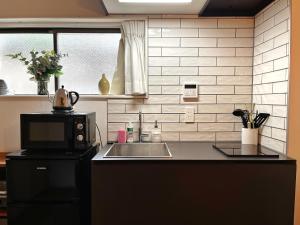 a kitchen with a sink and a microwave at Roppongi Place in Tokyo +115 photos