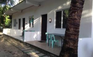 a table and chairs on the porch of a house at Eufro's Place in Guiuan