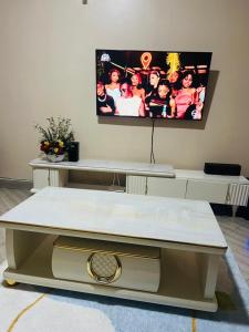 a living room with a tv on the wall at Jaza homes in Baruti West
